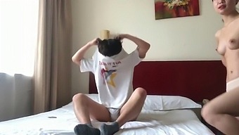 A Pair Of Lovers From China Enjoying Themselves In A Hotel Room